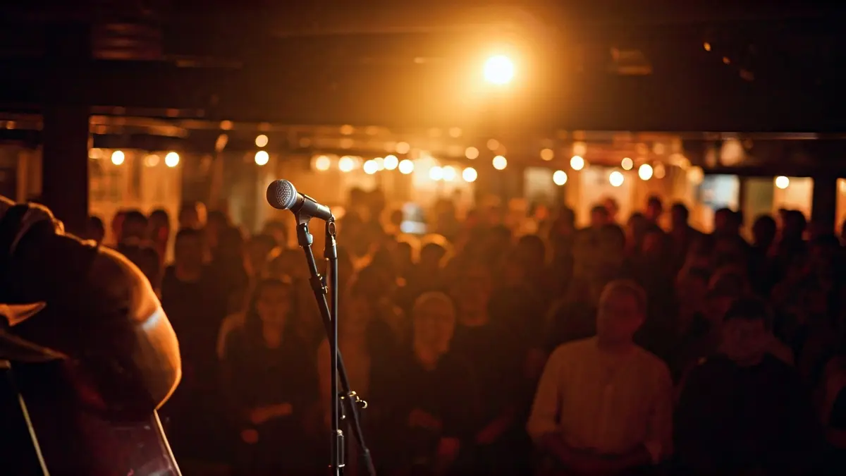 Generic image of an intimate concert with a guitar and microphone on a stage.