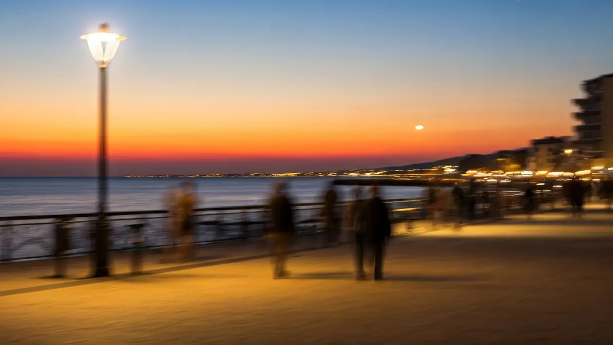 Generic image of a street light illuminating a pedestrian walkway at dusk.