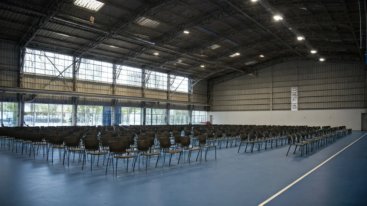 Generic image of a multi-purpose hall set up for an examination with chairs and tables.