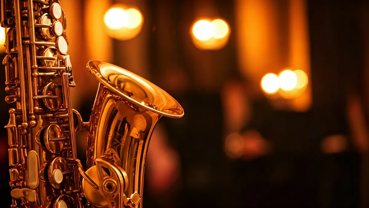 Generic image of a saxophone, focusing on the keys and polished brass, with a blurred background of musical notes.