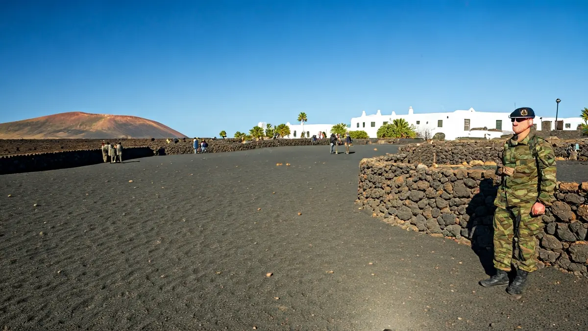 Military personnel patrolling in Lanzarote, with a volcanic landscape in the background.