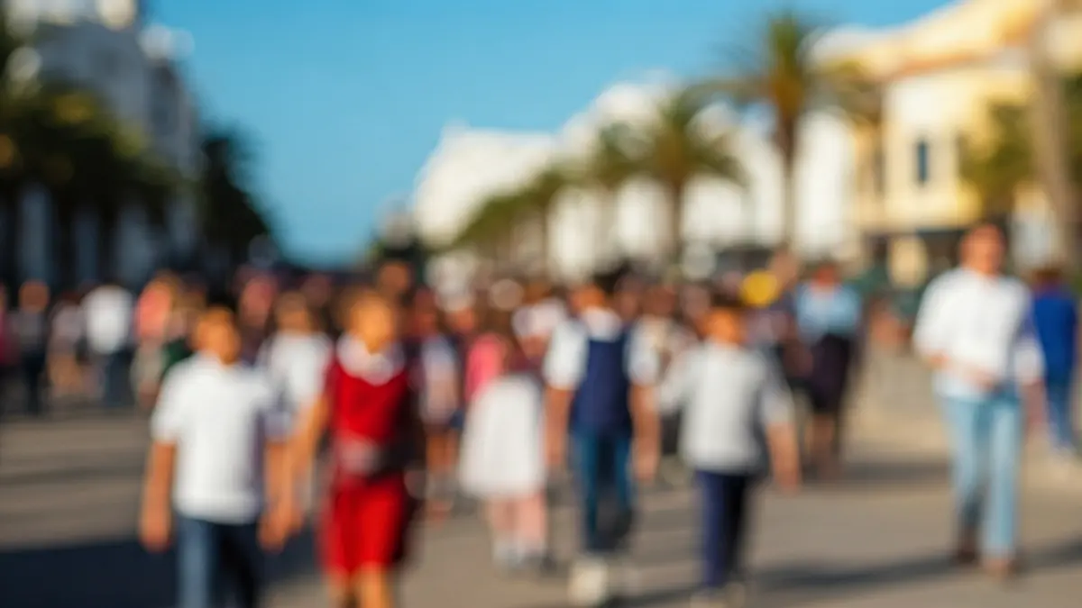 Image of a school parade for autism in Fuerteventura, with children and adults walking along a maritime avenue.
