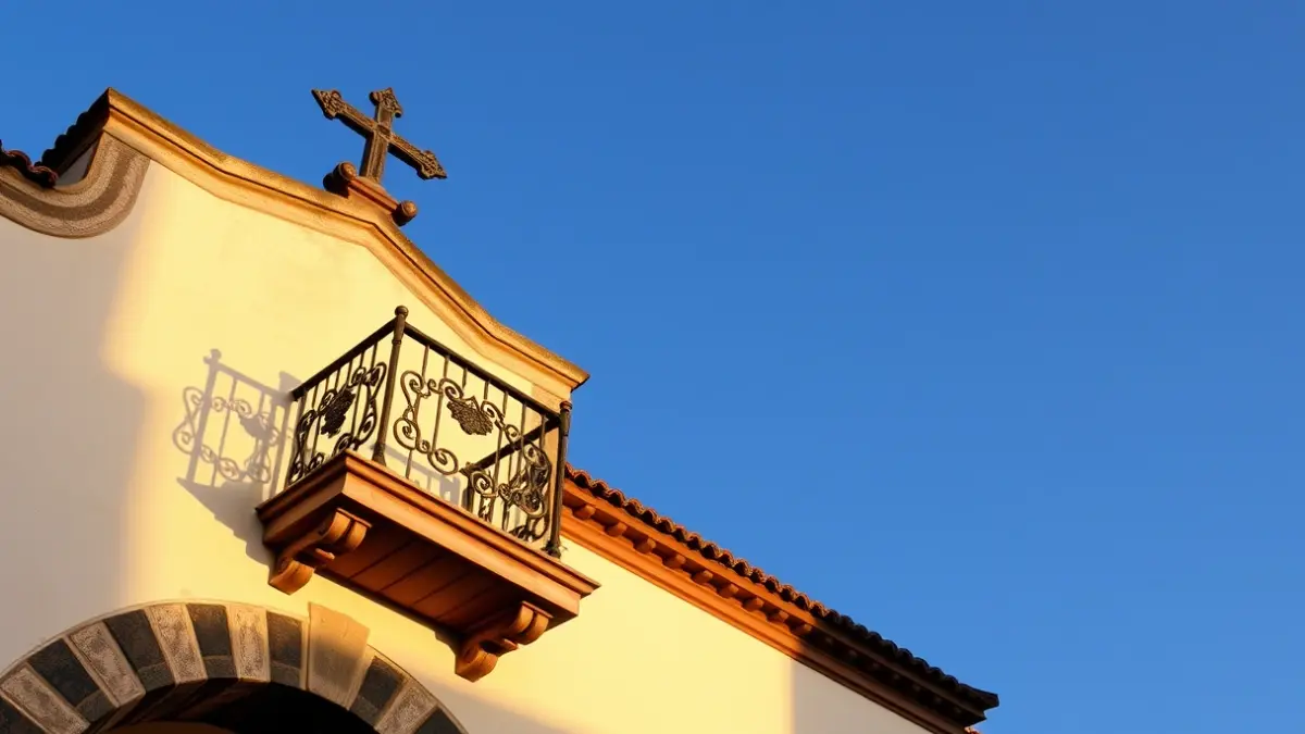 Facade of a Canarian town hall with a balcony and iron railings, under sunlight.
