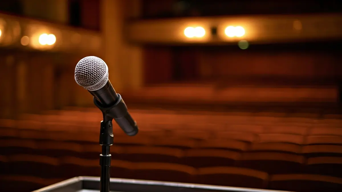 Generic image of a microphone on a podium in a theater.