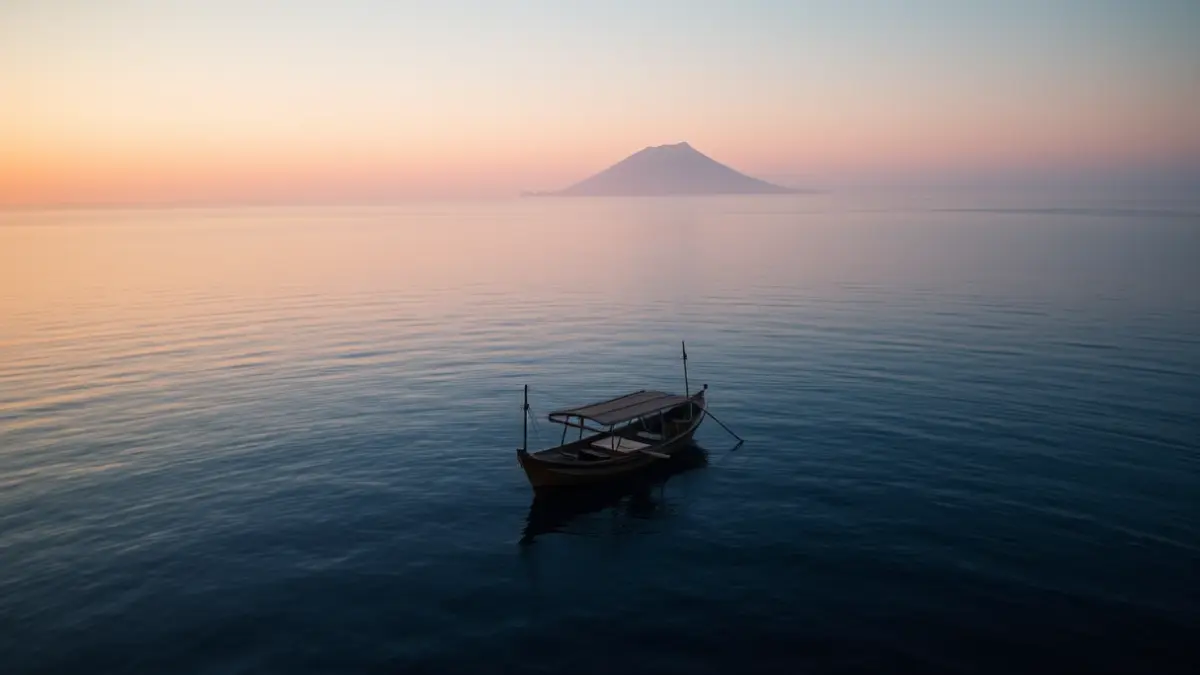 Generic image of a patera at sea at sunrise, with a volcanic island in the background.