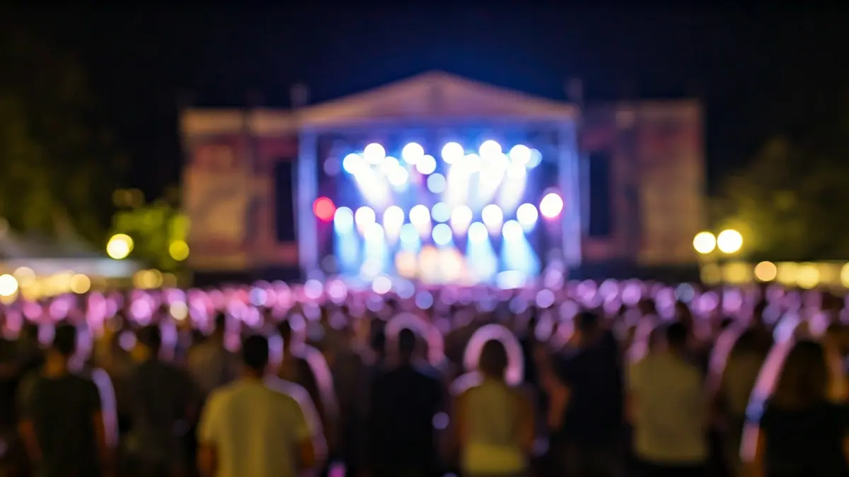 Generic image of an outdoor music festival with stage lights and dancing crowd.