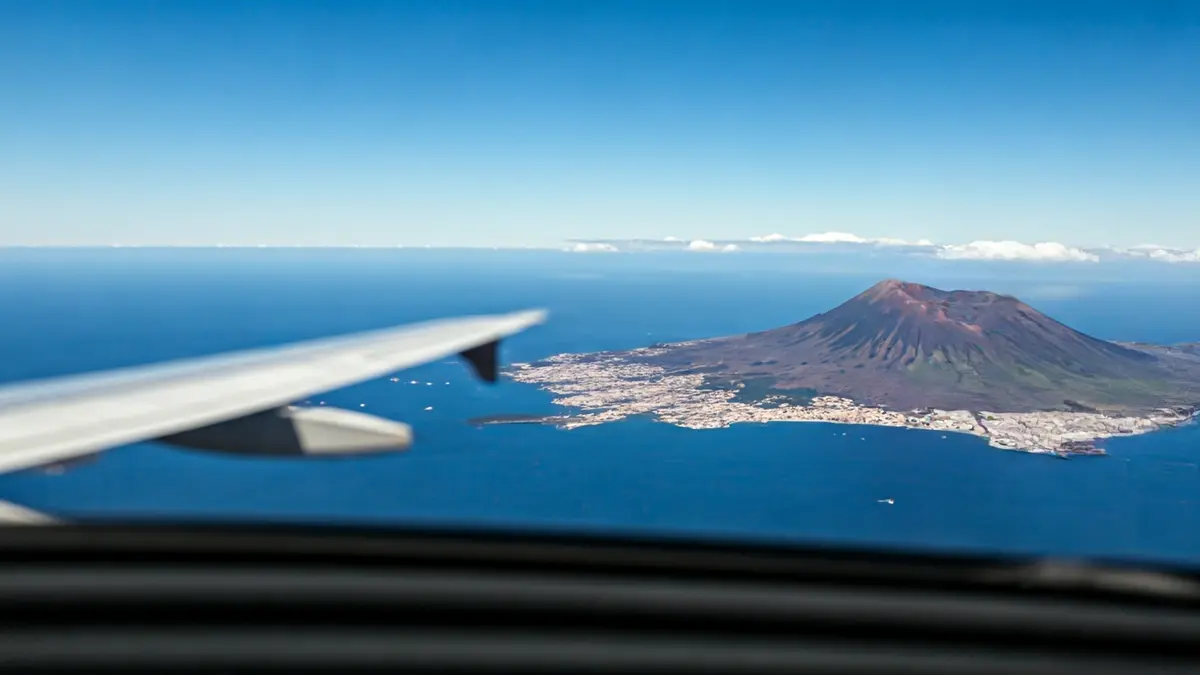 Image of a low fuel gauge, with an airplane and volcanic landscape in the background, symbolizing kerosene scarcity.