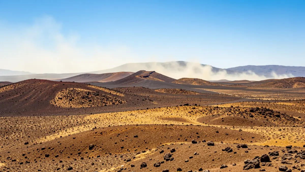 Paisaje volcánico de Canarias con sol intenso y calima.