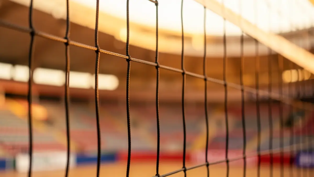 Generic image of a volleyball net in a sports arena.