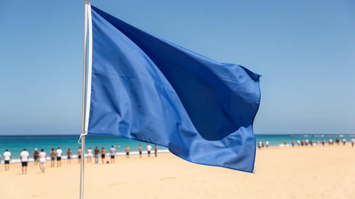 Blue flag waving on a beach in Fuerteventura.