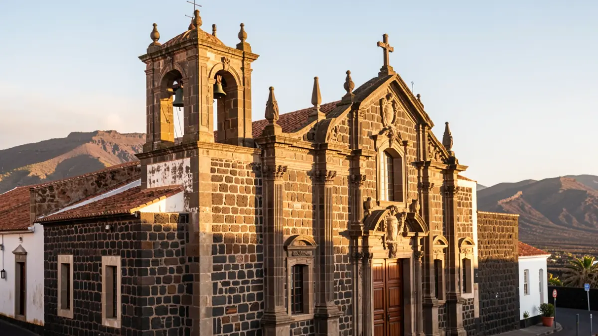 Historic church facade in the Canary Islands with volcanic landscape.