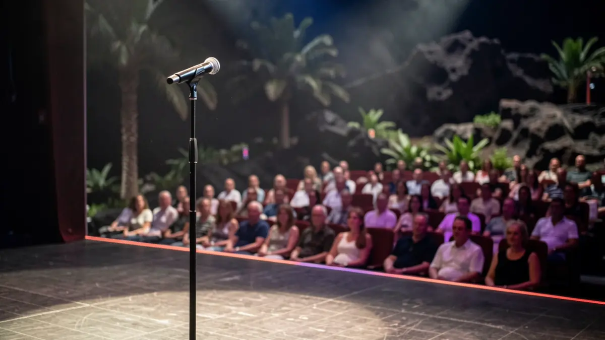 Generic image of a theater stage with a microphone.