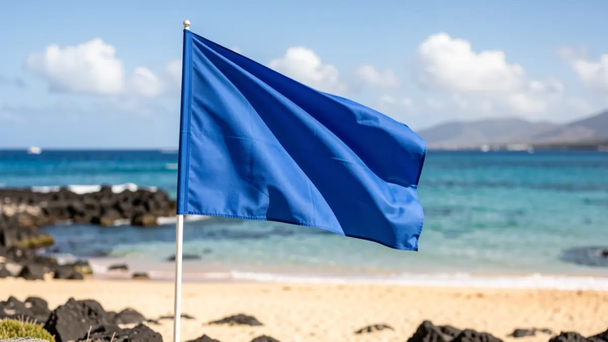 Blue flag waving on Arinaga beach, Gran Canaria.