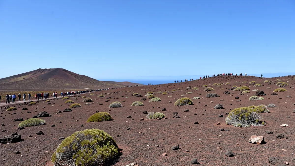 Generic volcanic landscape of Lanzarote with arid terrain and sparse vegetation.