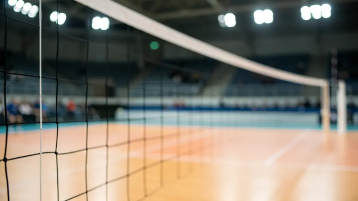 Generic image of an empty volleyball court with stadium lights.