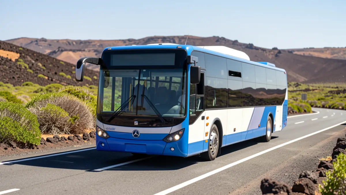 Image of an electric bus driving on a Fuerteventura road with volcanic landscape.