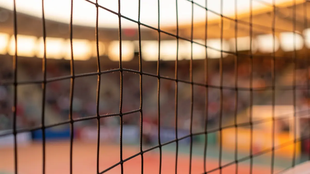 Generic image of a volleyball net in a sports arena.