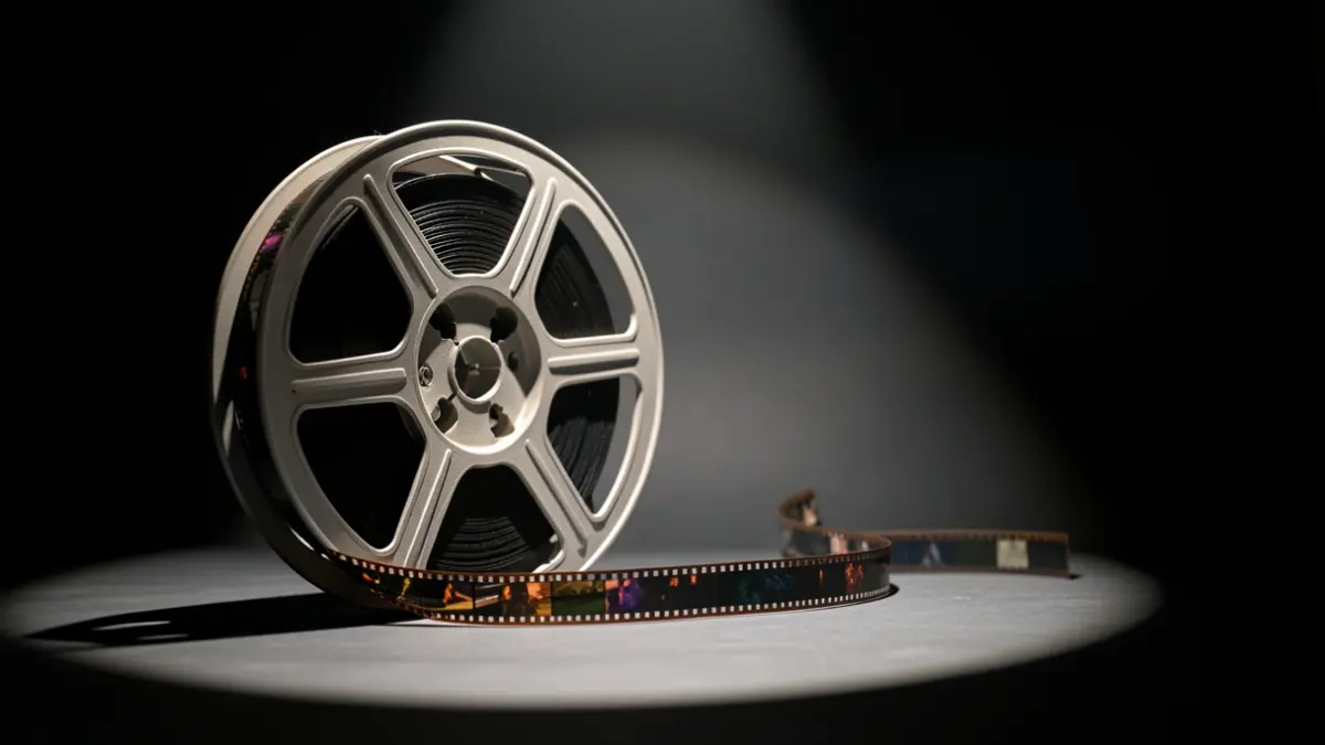 Film reel illuminated with color details.
