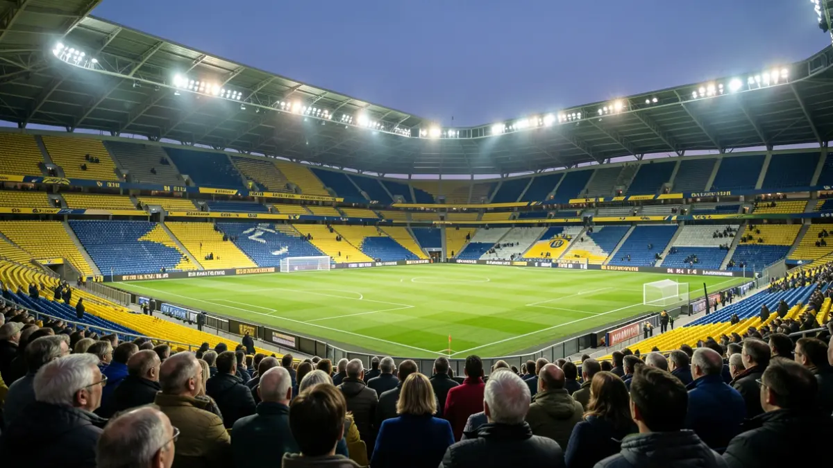 Generic image of a football stadium at dusk with the pitch illuminated.