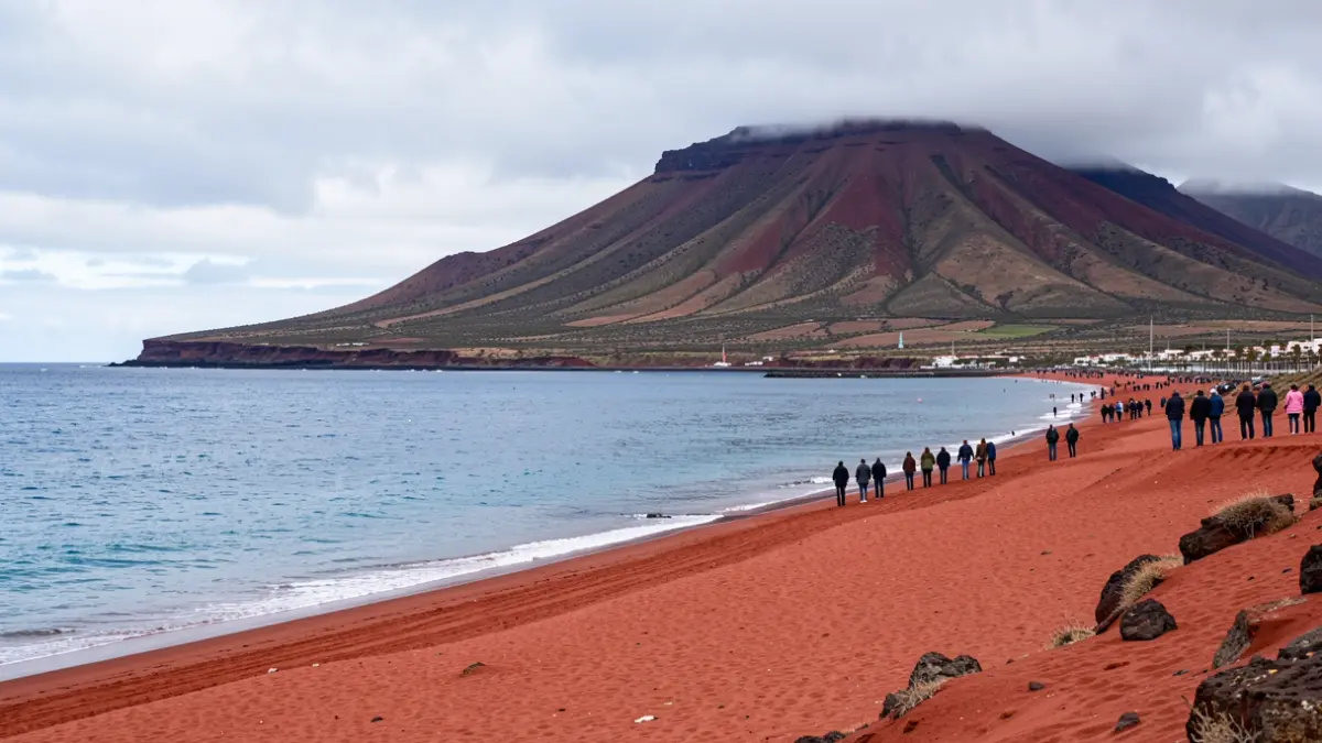 La Tejita beach in Tenerife, with Red Mountain and the sea, under a sky suggesting environmental threats.
