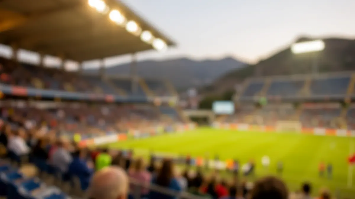 Imagen genérica de un estadio de fútbol con asientos vacíos bajo luces cálidas.