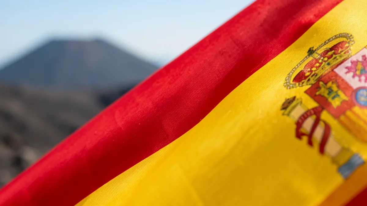 Generic image of the Spanish flag with a blurred volcanic landscape.