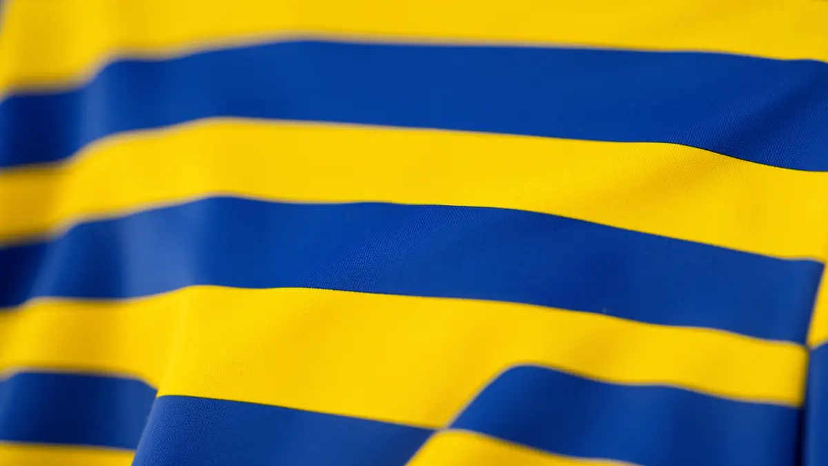 Detail of the texture of a soccer jersey with a striped design.