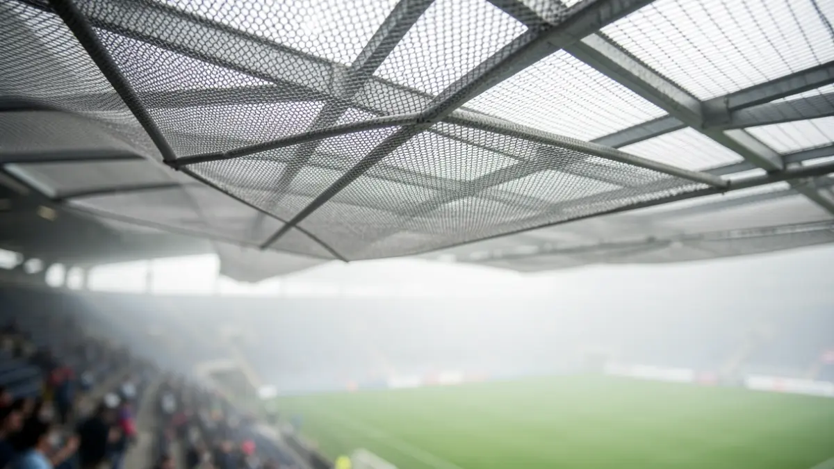 Detail of a mesh fog collector integrated into the roof of a sports stadium.