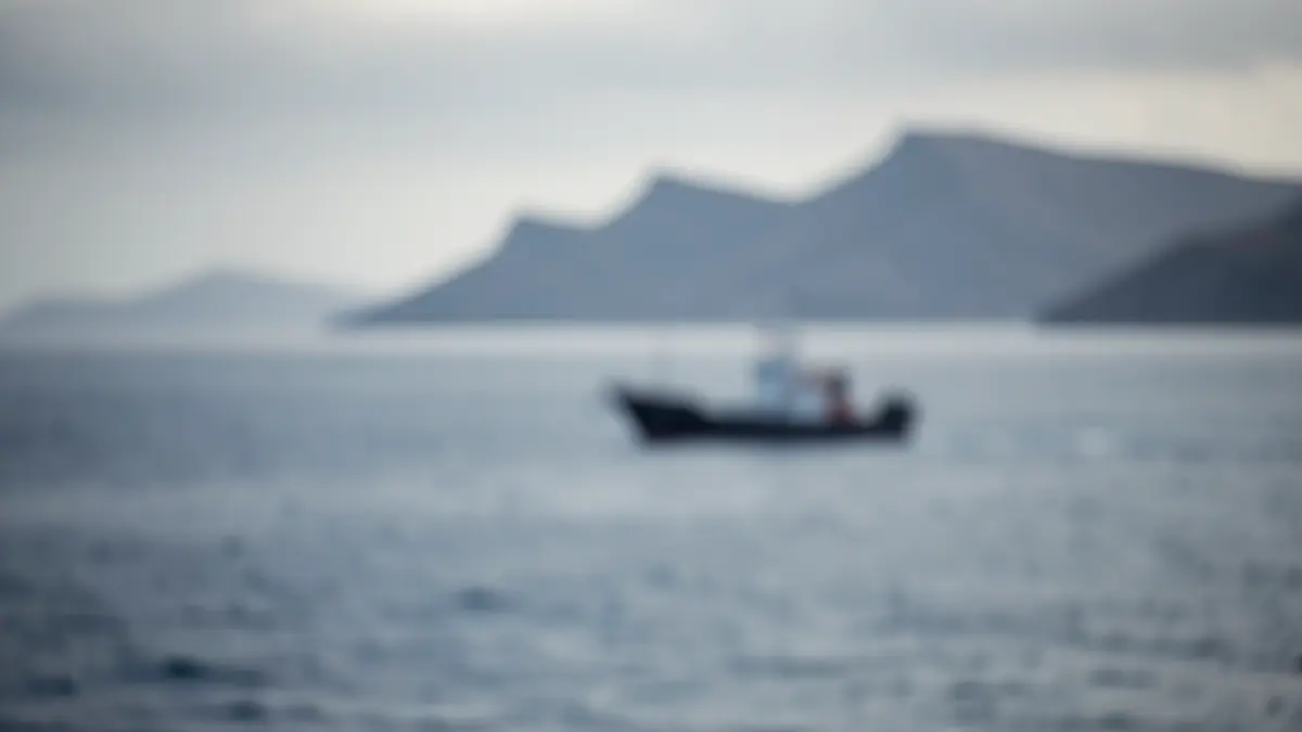 Symbolic image of migration control in the Canary Islands, with a silhouette of a boat on the horizon and volcanic islands.
