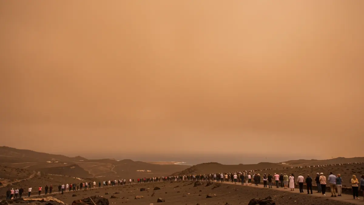 Generic image of an orange, dusty sky over a volcanic landscape in the Canary Islands.