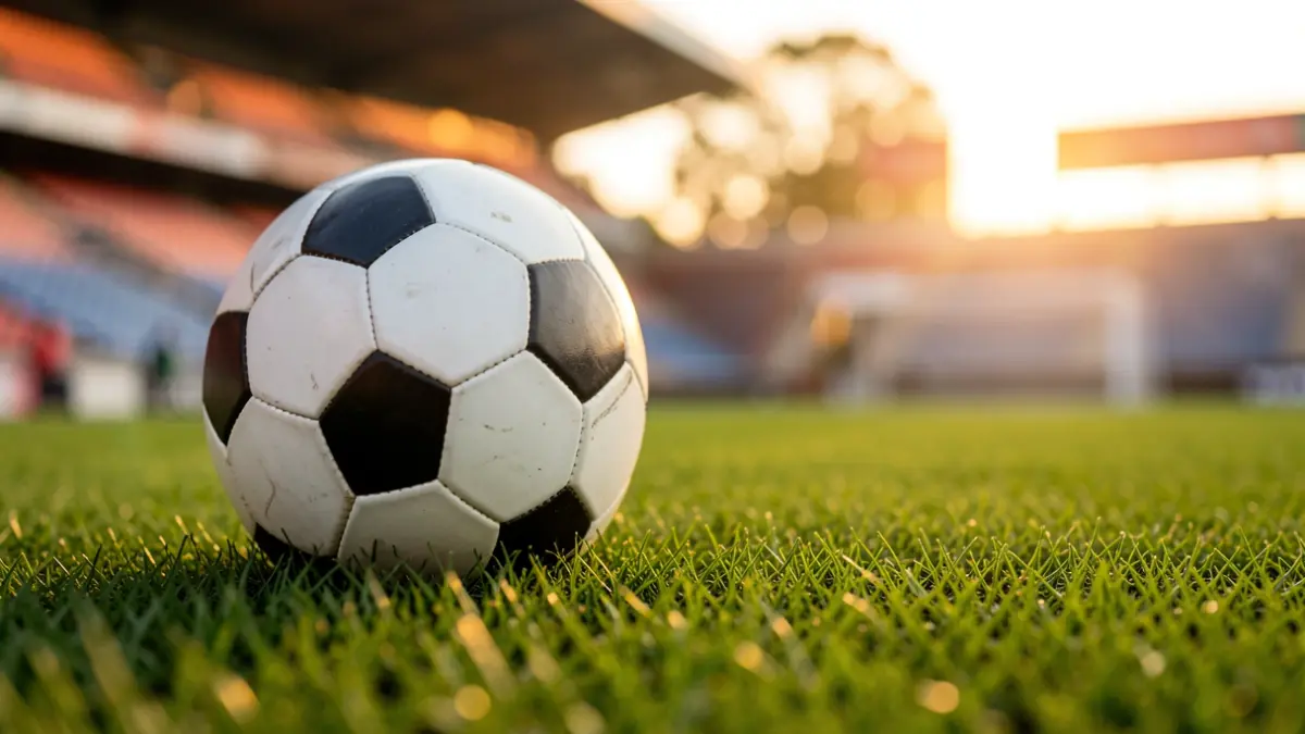 Generic image of a soccer ball on a stadium pitch.